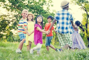 Diverse Children Holding Hands and Dancing in The Park