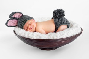 A newborn baby wearing a bunny costume